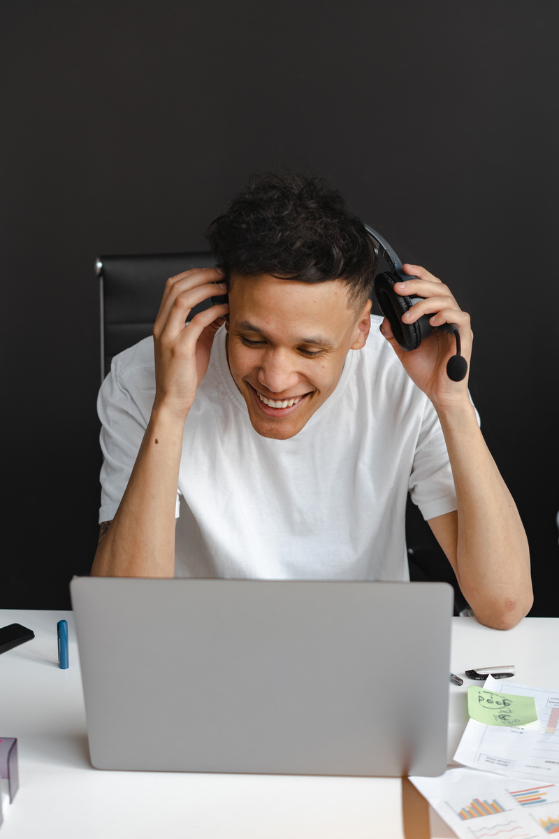 Laughing Man in White Shirt Working in a Call Center